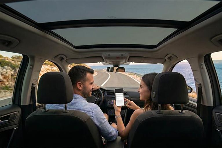 Par koristi mobilni internet tokom putovanja automobilom pored mora u inostranstvu